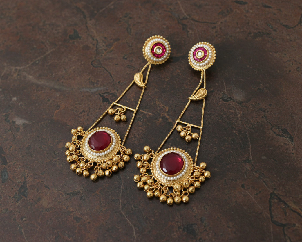 Golden earring with red stone