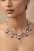 Silver necklace with red stones on a white background