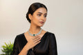 White diamond necklace with green gemstone
