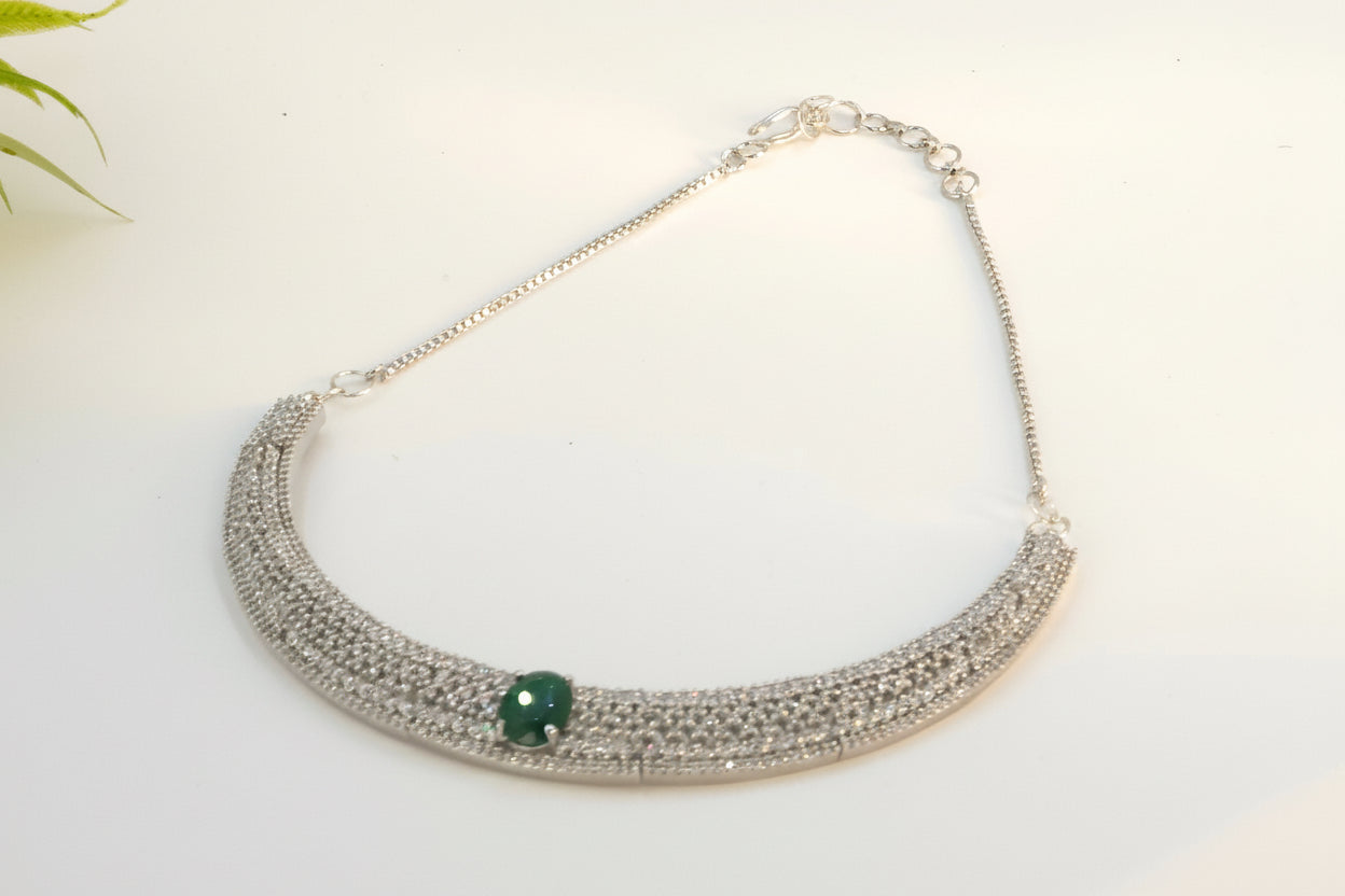 White diamond necklace with green gemstone